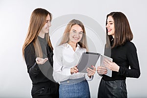 Three smiling business women standing in a row isolated on white background. Business Group people. Happy Business Team.