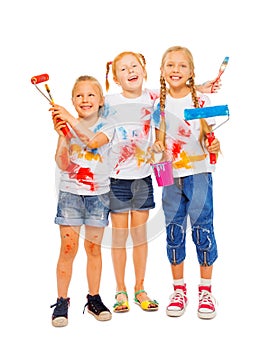 Three smiling girls with brushes
