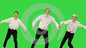 Three smiling guys in white shirts doing synch dance routine looking at camera on a Green Screen, Chroma Key.