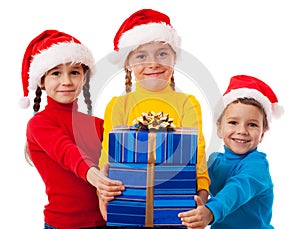 Three smiling kids with Christmas gift