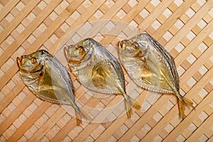 Three smoked sea fish Selene close-up on a string