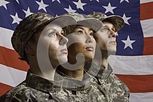 Three soldiers posed in front of American flag, horizontal photo
