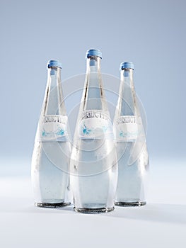 Three sparkling water glass bottles with fake label on blue background