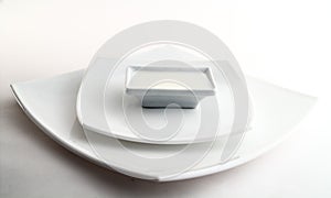 Three square white plates with milk