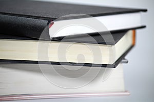 Three stacked books on white background