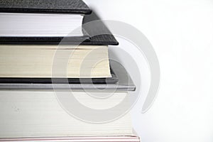 Three stacked books on white background