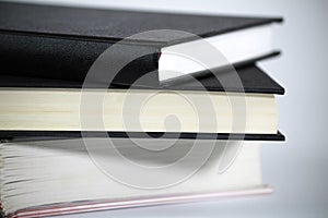 Three stacked books on white background