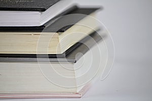 Three stacked books on white background