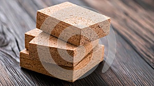 Three stacked cork blocks on a wooden surface.
