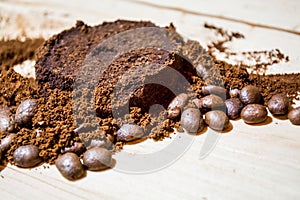 Three stages for preparation of coffee: grain, crushing and the pressed tablet. Wooden surface. Espresso. Work barista.