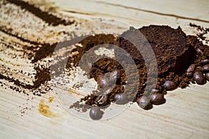 Three stages for preparation of coffee: grain, crushing and the pressed tablet. Wooden surface. Espresso. Work barista.