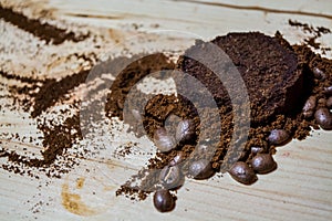 Three stages for preparation of coffee: grain, crushing and the pressed tablet. Wooden surface. Espresso. Work barista.