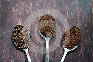 Three stages of spoons in coffee - beans, ground, instant