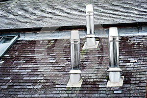 Three stainless steel chimneys