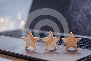 Three Stars on laptop for average and mediocre survey concept