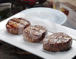 Three steaks roasted on the grill