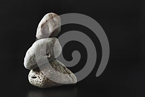 Three stones stand on top of each other keeping their balance.