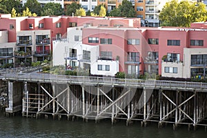 Three-story apartments on wooden stilts on the banks of the Willamette River in Portland