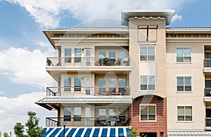 Three Story Condo Over Blue and White Awning
