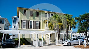 Three-story houses with white pergola and picket fence curb appeal along scenic 30A country road in Santa Rosa, South Walton,