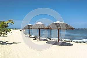 Three straw parasol, on tropical and paradisiac beach