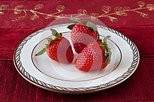 Three Strawberries on a Plate