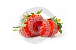 Three strawberries with strawberry leaf on white background