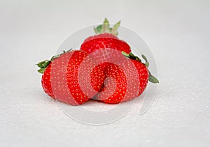 Three strawberries on white background