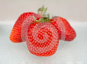 Three strawberries on white background