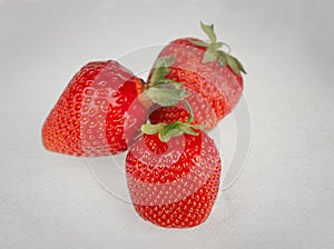 Three strawberries on white background
