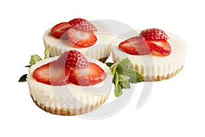 Three strawberry cheesecakes isolated