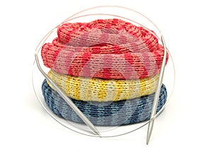 Three striped reeled up knitting scarfs