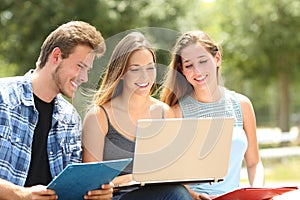 Three students e-learning together in a campus