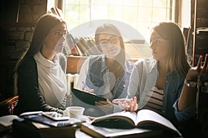 Three students girl learning together and using smart p