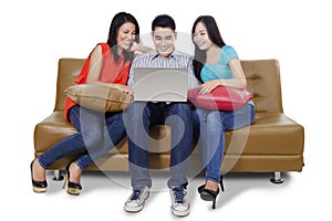Three students and laptop on the couch