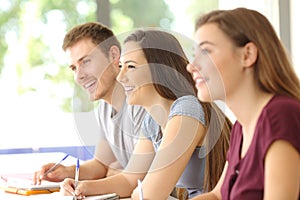 Three students listening in a classroom