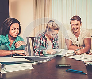 Three students preparing for exams in home interior photo