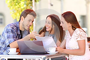 Three students studying and learning in a coffee shop