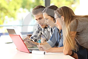 Three students studying together on line