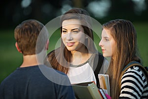 Three Students Talking Outdoors