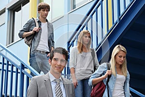 Three students walking down stairs