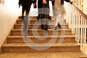 three students walking down the stairs at school