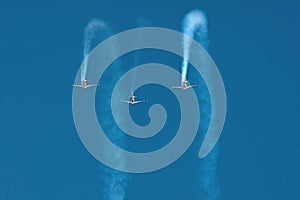 Three stunt planes flying in formation towards camera
