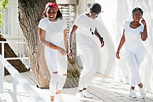 Three stylish african american friends, wear on white photo