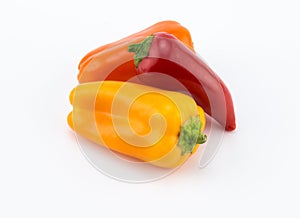 Three sweet orange, red and yelllow peppers on white background