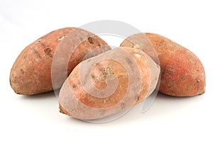 Three sweet potatoes isolated on white background