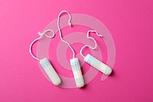 Three tampons on background, top view