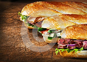 Three tasty baguettes with savory fillings photo