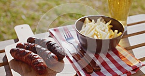 Three tasty smoked grilled sausages with chips