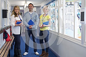 Three Teachers in School Corridor